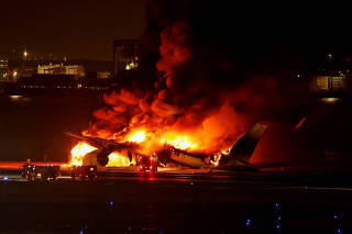 FILE PHOTO: Japan Airlines' A350 airplane on fire at Haneda international airport in Tokyo