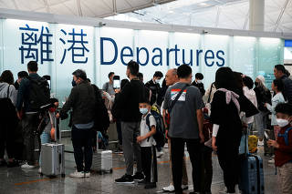 FILE PHOTO: Travellers at Hong Kong International Airport