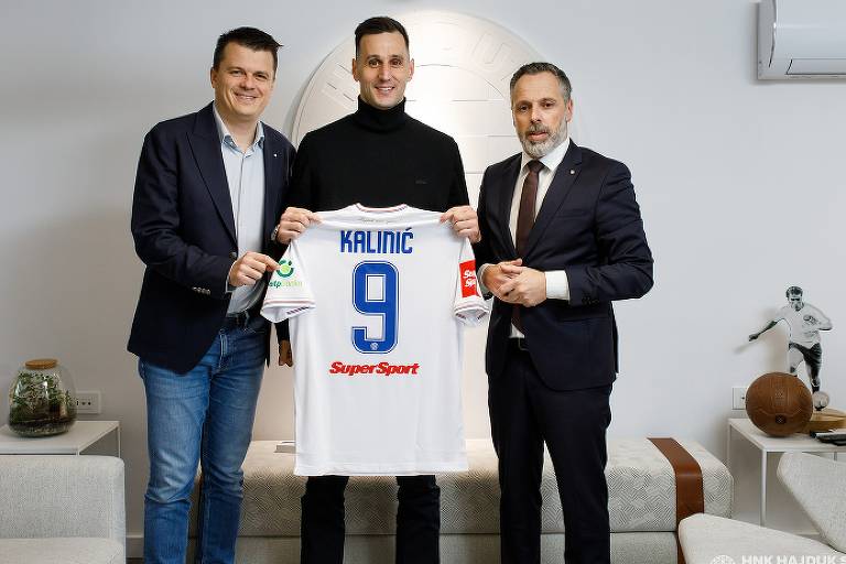 Nikola Kalinic exibe sorrindo a camisa com o número 9 do Hajduk Split entre representantes do clube croata