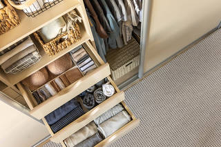Modern wardrobe with stylish women's clothing. Drawer with underwear, t-shirts, socks and shorts. The concept of storage and order.