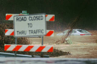 A car lies in flood waters after heavy rainfalls moved in through the area of Spartanburg