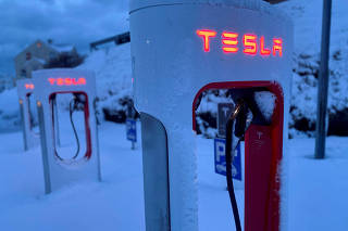 Tesla electric vehicle chargers are seen during the winter in Hofn