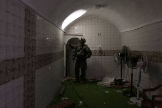 A soldier standing in an underground compound where the Israeli military said hostages had been held by Hamas, as photographed during an escorted tour, on Jan 19. 2024. (Isabel Kershner/The New York Times)