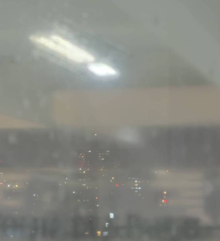 Foto sob baixa luminosidade fica granulada em função da maior sensibilidade dos sensores óticos. Imagem mostra visão noturna de prédios do centro de São Paulo