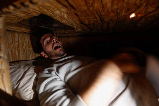 Gamers play an extreme escape room named Catalepsia inside coffins, in Barcelona