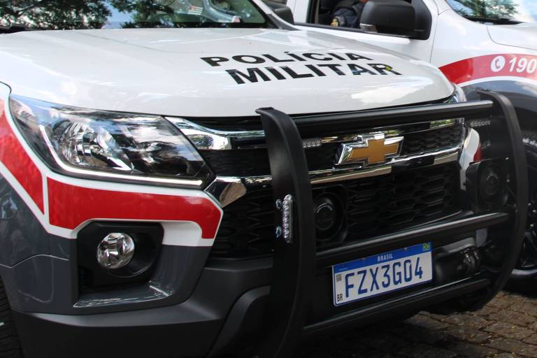 Viaturas da Polícia Militar de frente, com capô branco e faixa vermelha na lateral até o farol
