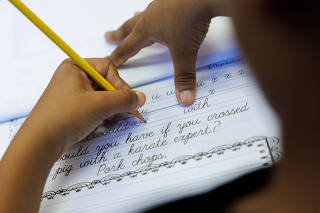 A generation of children who learned to write with their thumbs are now going old school in California