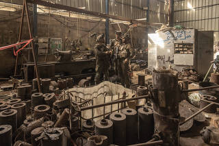 Israeli soldiers stand in what they described as a rocket factory, during an escorted tour by the military for international journalists in the central Gaza Strip on Jan. 8, 2024. (Avishag Shaar-Yashuv/The New York Times)
