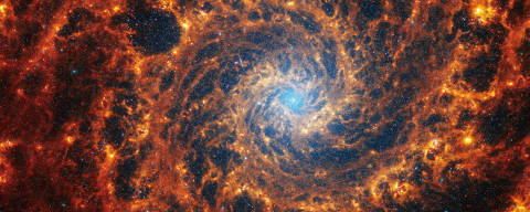 Spiral galaxy NGC 628, located 32 million light-years away from Earth, is seen in an undated image from the James Webb Space Telescope. Webb?s image of NGC 628 shows a densely populated face-on spiral galaxy anchored by its central region, which has a light blue haze that takes up about a quarter of the view. NASA, ESA, CSA, STScI, Janice Lee (STScI), Thomas Williams (Oxford), and the PHANGS team/Handout via REUTERS   THIS IMAGE HAS BEEN SUPPLIED BY A THIRD PARTY ORG XMIT: PPP-VAN104