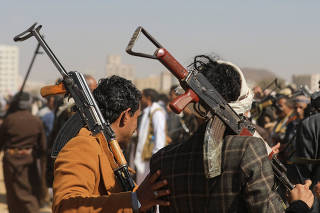 Armed Houthi followers parade in Sanaa