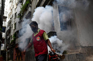 A city worker fumigates as the mosquito-borne dengue infection worsens in Dhaka