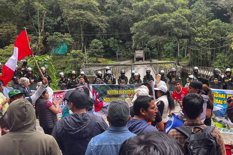 Membros da polícia montam guarda na entrada das ruínas de Machu Picchu enquanto operadores turísticos e moradores realizam greve e manifestação contra a abertura da venda online de ingressos para as ruínas da cidadela Inca, em Machu Picchu Pueblo, Peru, em 26 de janeiro de 2024 .