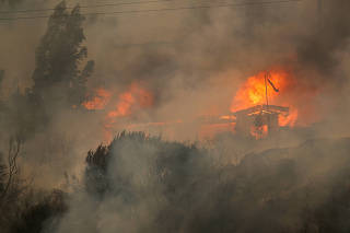 Houses burn amid the spread of wildfires in Vina del Mar