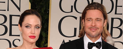 (FILES) In this file photo taken on January 15, 2012 actors Angelina Jolie and Brad Pitt arrive at the 69th Annual Golden Globe Awards held at the Beverly Hilton Hotel in Beverly Hills, California. - Brad Pitt allegedly hit one of his children in the face and choked another during a fight with Angelina Jolie on a private plane, according to court papers filed October 4, 2022 in the United States by his ex-wife. (Photo by Jason Merritt / GETTY IMAGES NORTH AMERICA / AFP)