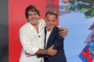Soma Group CEO Roberto Jatahy greets Arezzo&Co's CEO Alexandre Birman during a news conference in Sao Paulo