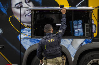 Policial rodoviário federal inspeciona ônibus de turismo vindo do Paraguai em abordagem 
