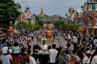 FILE PHOTO: Visitors watch the Halloween program featuring Disney character Mickey Mouse at a parade at Hong Kong Disneyland