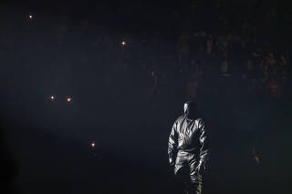 A figure onstage for the release party for ÒVultures 1,Ó in which Ye, or Kanye West, performed but never removed a mask, at UBS Arena in Elmont, N.Y., after midnight on Feb. 10, 2024. (The New York Times)