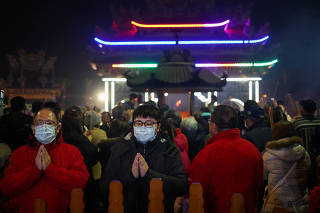 People pray at a temple during Lunar New Year celebrations in New Taipei city