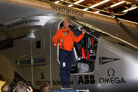 Bertrand Piccard of Switzerland boards his solar powered aircraft Solar Impulse 2 as he prepares to takes off from  John F. Kennedy International Airport in New York early on June 20, 2016.  The sun-powered Solar Impulse 2 aircraft set off from New York's JFK airport early June 20, embarking on the transatlantic leg of its record-breaking flight around the world to promote renewable energy. / AFP PHOTO / TREVOR COLLENS ORG XMIT: TWC15