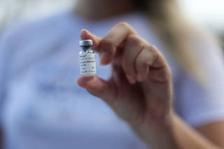 A health worker holds a sample dengue vaccine Qdenga, during a vaccination campaign, in Rio de Janeiro