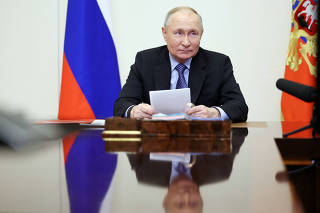 FILE PHOTO: Russian President Putin chairs a meeting with members of the Security Council via video link outside Moscow