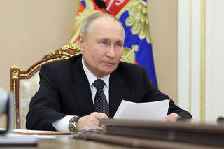 Russian President Vladimir Putin chairs a meeting via video link in Moscow