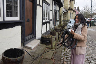 Clare Tan gets ready to charge her electric BYD Atto 3 using a home charger in Berkhamsted