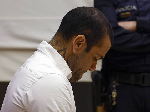 Brazilian footballer Dani Alves looks down during his trial at the High Court of Justice of Catalonia in Barcelona, on February 5, 2024. Brazilian footballer Dani Alves, a former star at Barca and PSG, goes on trial in Barcelona accused of raping a woman in a local nightclub. Prosecutors are asking for a nine-year prison sentence, followed by 10 years of conditional liberty. They are also asking he pay 150,000 euros ($162,000) in compensation to the woman. (Photo by ALBERTO ESTÉVEZ / POOL / AFP) ORG XMIT: GRAF7964