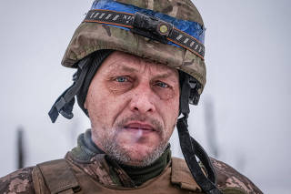 A Ukrainian serviceman of 2 battalion 92nd brigade stands near a dugout at a position near Bakhmut