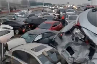 Cars pile up on an overpass during rainy and snowy weather, in Suzhou
