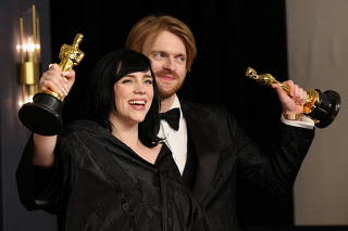 FILE PHOTO: Billie Eilish and Finneas O'Connell pose with their Oscars for Best Original Song for 