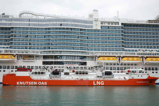 An LNG ship loads gas to a cruise ship in Barcelona