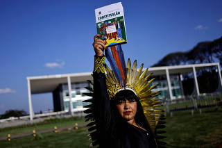 Brazilian Xokleng Indigenous people celebrate after a majority in Brazil's Supreme Court voted against the constitutionality of laws to limit the ability of Indigenous people to win protected status for ancestral lands, in Brasilia