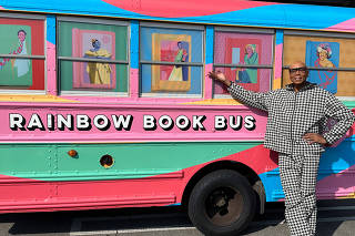 RuPaul, a co-founder of Allstora, an online bookstore, with a rainbow school bus that will be traveling from the West Coast to the South to distribute books targeted by book bans.