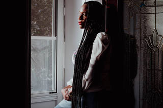 Trish Michelle, a stage 3 cancer survivor, at home in Queens on Feb. 26, 2024. (Laila Stevens for The New York Times))