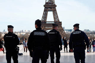 FILE PHOTO: French police and gendarmes patrol near the Eiffel Tower in Paris