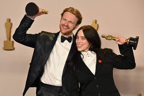 US singer-songwriter Billie Eilish and US singer-songwriter Finneas O'Connell pose in the press room with the Oscar for Best Original Song for 