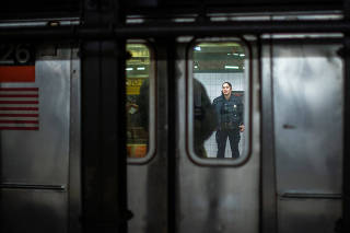 A New York City Police Department (NYPD) officer patrols inside of a subway station in New York