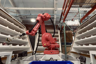 Covariant?s AI-powered Robotic Putwall system autonomously sorts items at the company?s headquarters in Emeryville, Calif., on March 8, 2024. (Balazs Gardi/The New York Times)