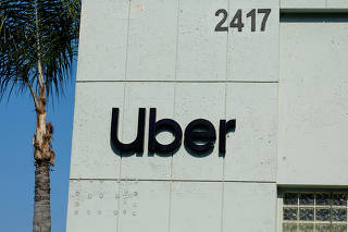 The Uber logo is shown on the building in Los Angeles