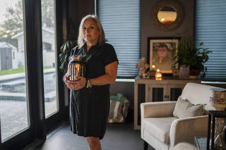 Sandra Bagwell holds the remains of her son, Ryan Bagwell, who died in 2022, in Mission, Texas, on Feb. 26, 2024. (Verónica G. Cárdenas/The New York Times)