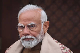 FILE PHOTO: India's PM Modi looks on after speaking with media inside parliament premises, in New Delhi