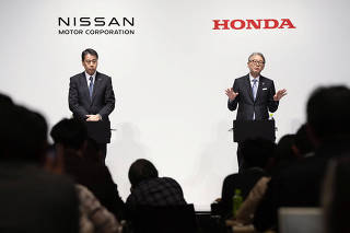 Makoto Uchida, president and CEO of Nissan Motor and Toshihiro Mibe, Honda Motor president and CEO, attend their joint press conference in Tokyo