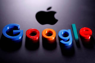FILE PHOTO: A 3D printed Google logo is placed on the Apple Macbook in this illustration