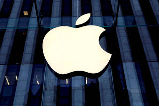 FILE PHOTO: The Apple logo is seen hanging at the entrance to the Apple store on 5th Avenue in Manhattan