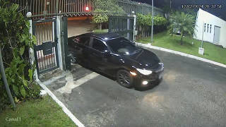 In an undated still image taken from security camera footage, a black car appears at 9:34 pm at the gate of the Hungarian Embassy in Brasilia, Monday, Feb. 12, 2024. (Via The New York Times)