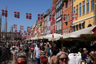 FILE PHOTO: Danish flags are seen hung over Nyhavn in Copenhagen