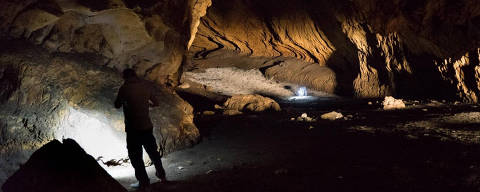 A person stands in Pebdeh Cave, in the southern Zagros Mountains, Iran, in this undated photo obtained by Reuters on March 25, 2024. Pebdeh Cave was occupied by hunter-gatherers as early as 42,000 years ago, inferred to be Homo Sapiens.  Mohammad Javad Shoaee/Handout via REUTERS  THIS IMAGE HAS BEEN SUPPLIED BY A THIRD PARTY.  NO RESALES. NO ARCHIVES ORG XMIT: GDN