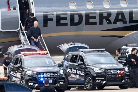 Counselor of the Rio de Janeiro Court of Audit Domingos Brazao walks down a Federal Police aircraft upon arrival in Brasilia on March 24, 2024, after being arrested in Rio de Janeiro, Brazil. . Brazilian police on Sunday arrested the alleged masterminds of the 2018 murder of Rio de Janeiro councillor Marielle Franco, potentially shedding new light on a killing that triggered an outcry in Brazil and beyond. (Photo by EVARISTO SA / AFP)